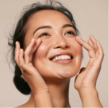 Asian woman smiling during a skincare routine